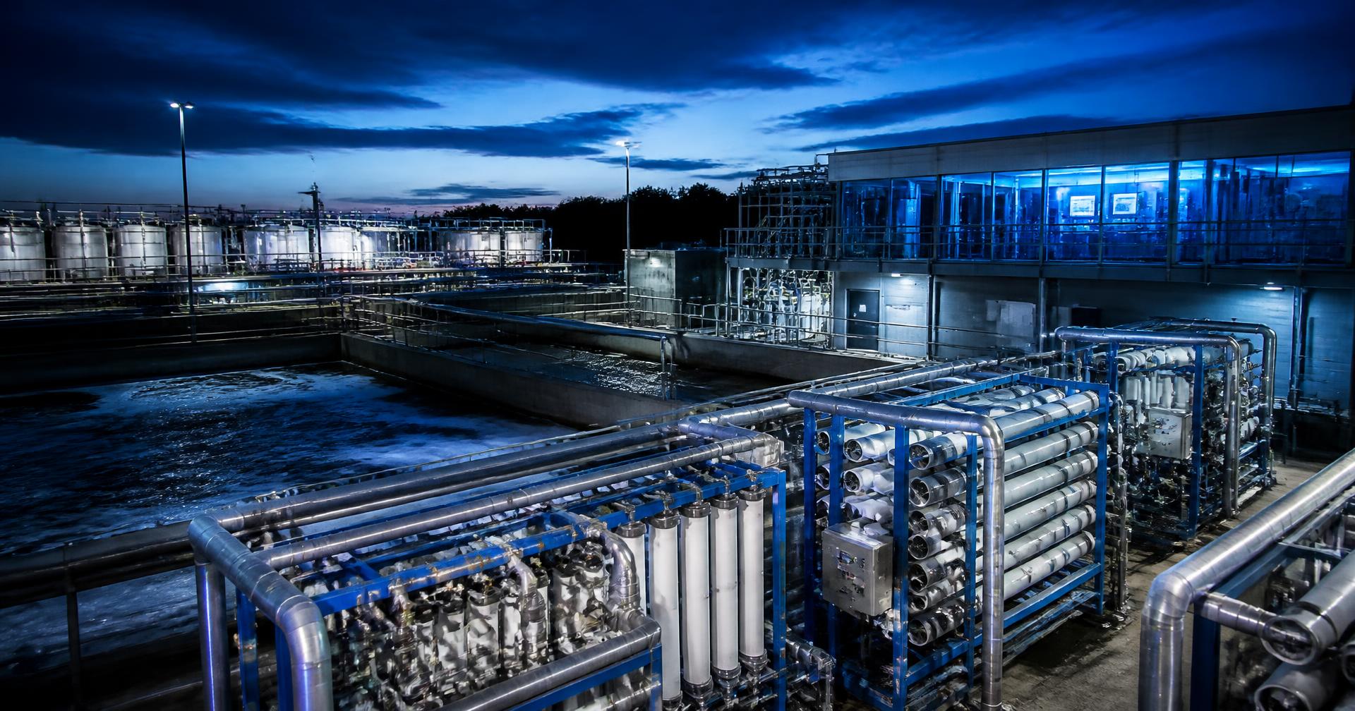 Industrial membrane water treatment plant illuminated at dusk